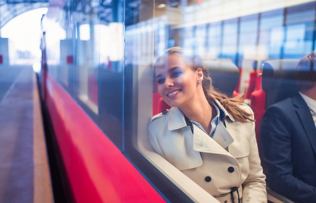 Passenger enjoying a scenic boat tour on the Seine River, Paris, with iconic Eiffel Tower in the background.