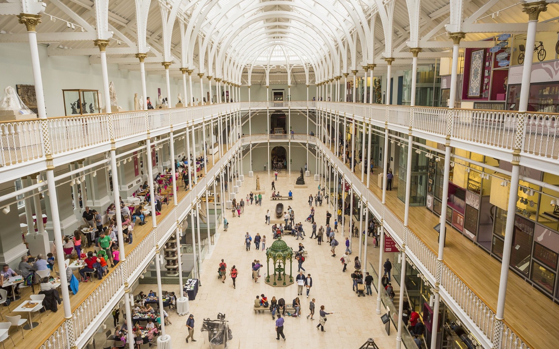 Visitors exploring the grand atrium of the National Museum of Scotland in Edinburgh.