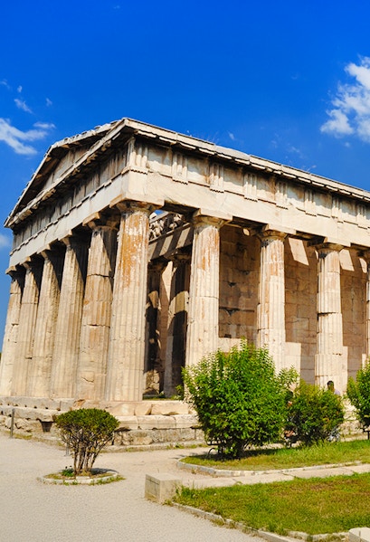 Temple of Hephaestus with Doric columns in Athens, Greece, under a clear blue sky.