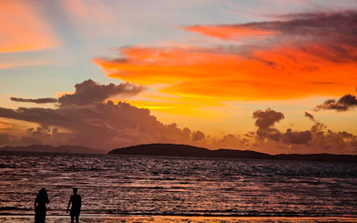 Sunset over Railay Beach with silhouettes of people, Krabi, Thailand.