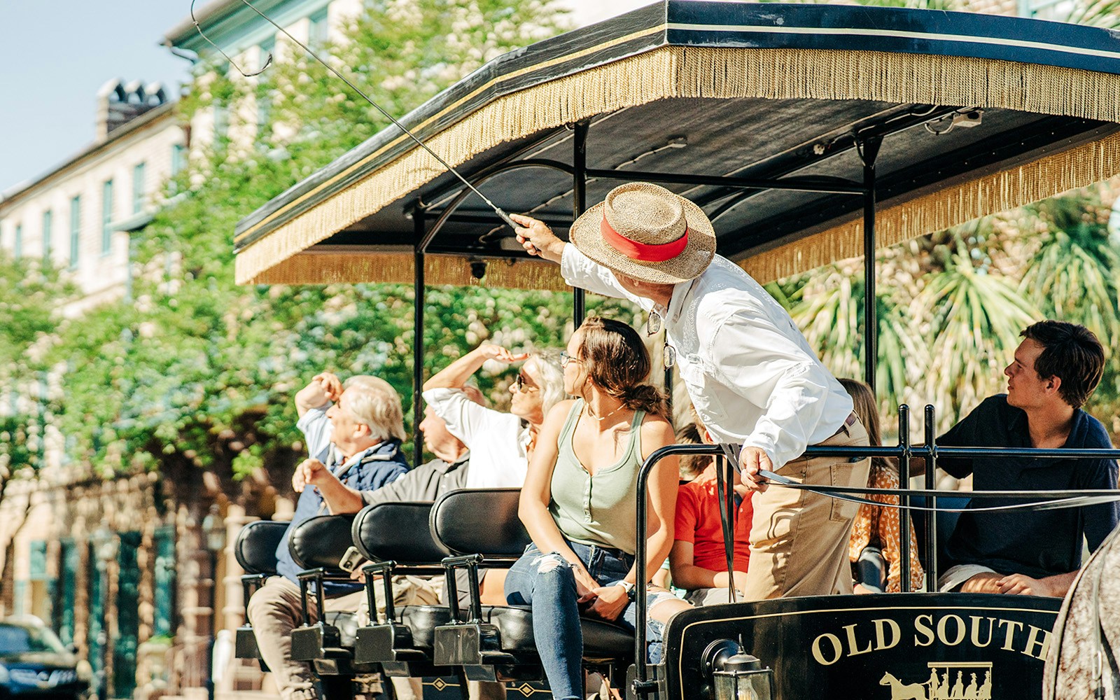 Tourists on a horse carriage tour with a guide in Charleston, South Carolina.
