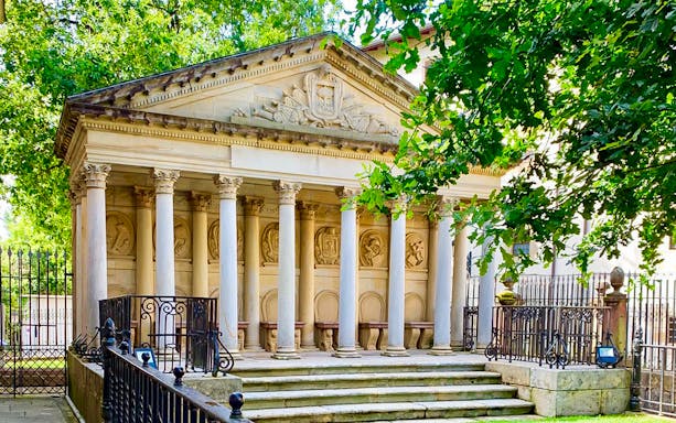 Neoclassical building with columns in Gernika, part of the San Sebastian tour.