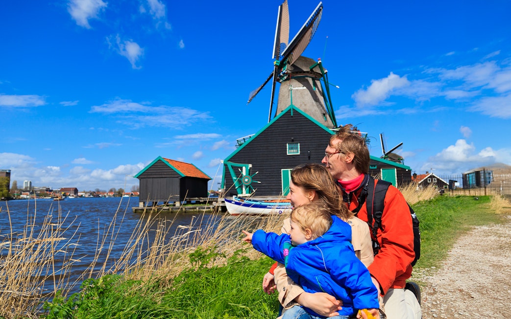Family enjoying view of windmills at Zaanse Schans, Netherlands.