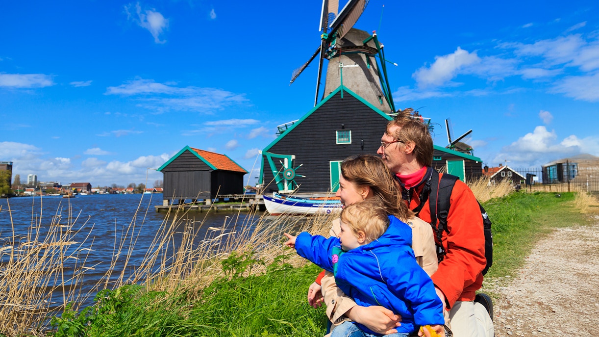 Family enjoying view of windmills at Zaanse Schans, Netherlands.