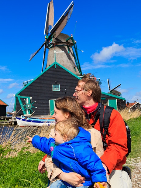 Family enjoying view of windmills at Zaanse Schans, Netherlands.