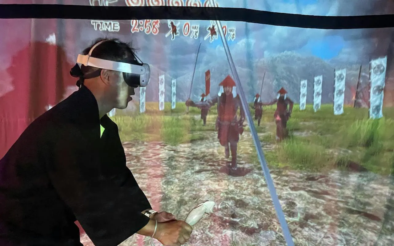 Person using VR headset in Osaka Ninja Workshop simulation.