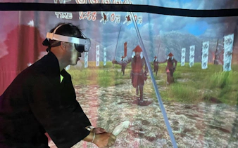 Person using VR headset in Osaka Ninja Workshop simulation.