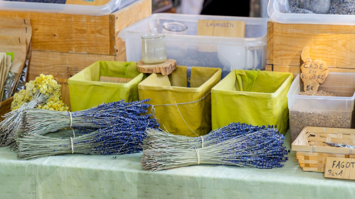 Lavender bundles and herbs displayed at a local market in Provence.