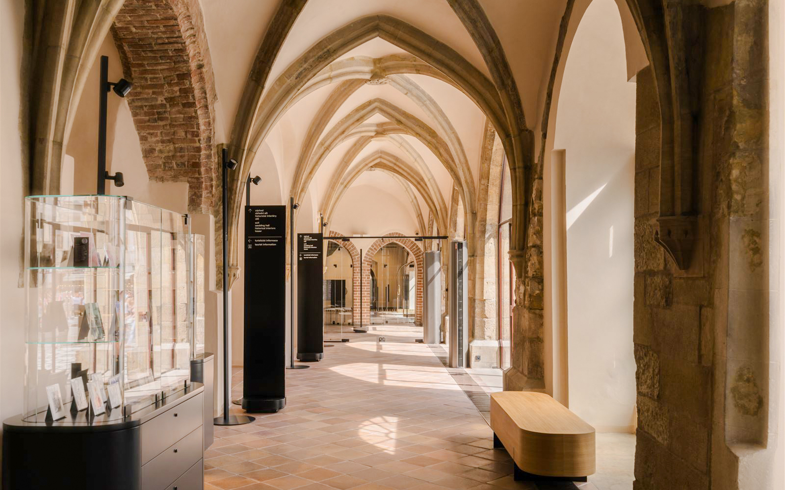 Gothic arches and display cases inside Old Town Hall, Prague.