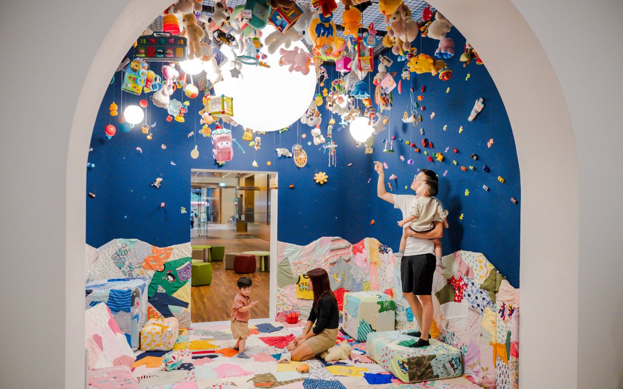Family exploring interactive art installation at Children's Biennale, National Gallery Singapore.