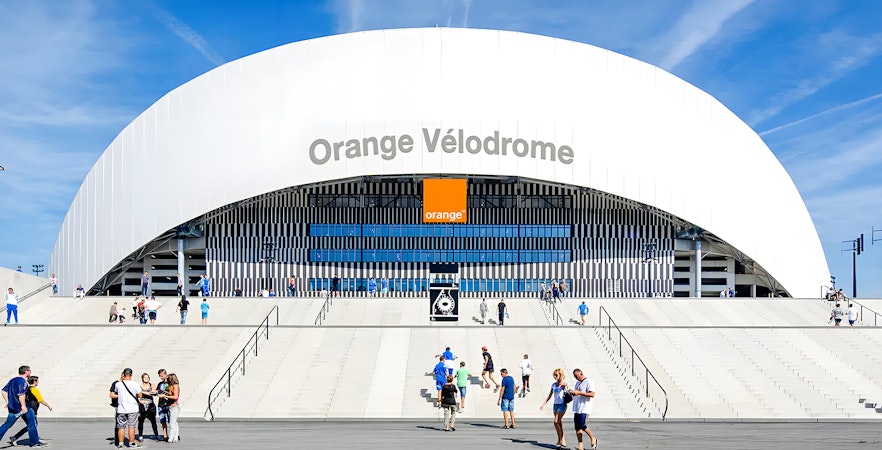 Orange Vélodrome stadium entrance with visitors in Marseille, France.