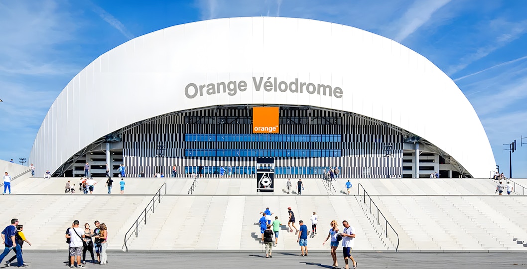 Orange Vélodrome stadium entrance with visitors in Marseille, France.