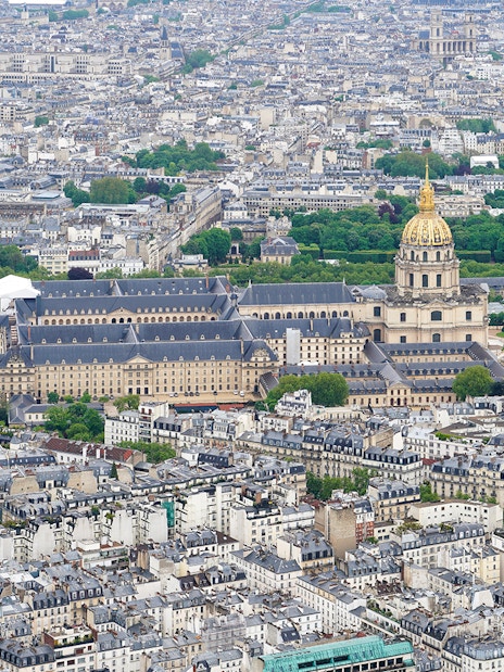 Aerial view of Paris from the Eiffel Tower, featuring Les Invalides and surrounding cityscape.