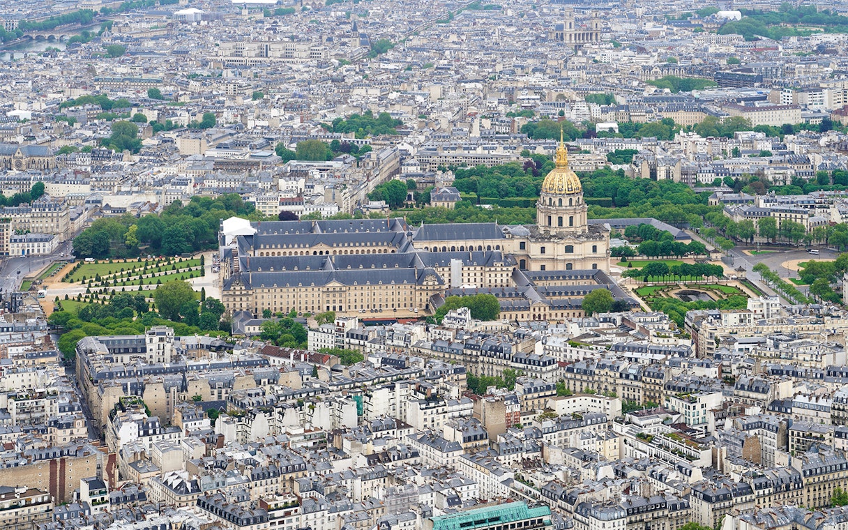 Aerial view of Paris from the Eiffel Tower, featuring Les Invalides and surrounding cityscape.