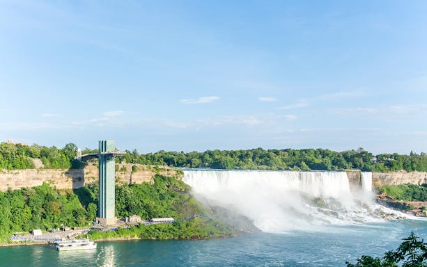 Panoramic view of Niagara Falls from the Niagara SkyWheel, featuring the observation tower and river.