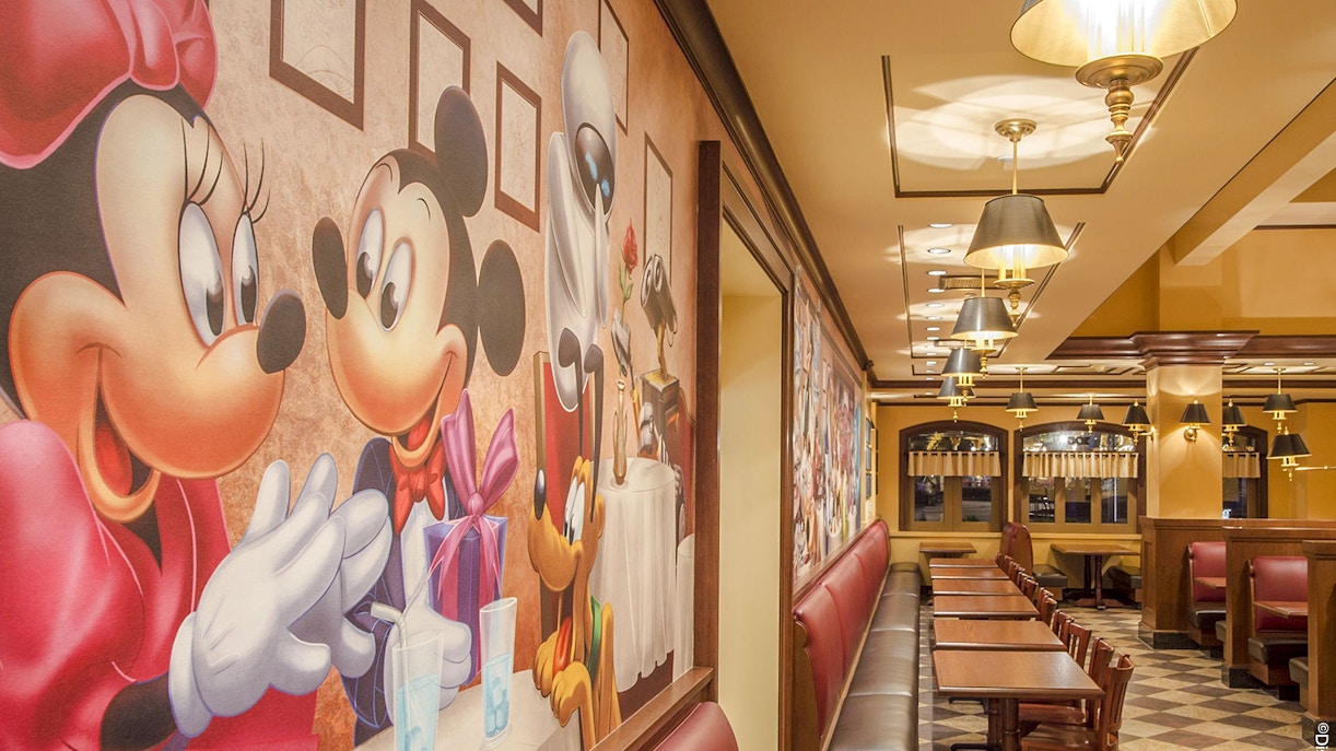 Shanghai Disney restaurant with character-themed wall art and seating area.