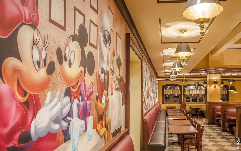 Shanghai Disney restaurant with character-themed wall art and seating area.