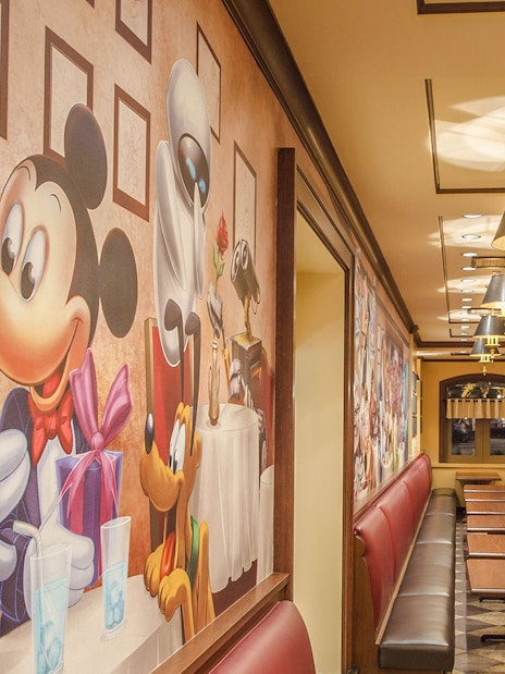 Shanghai Disney restaurant with character-themed wall art and seating area.
