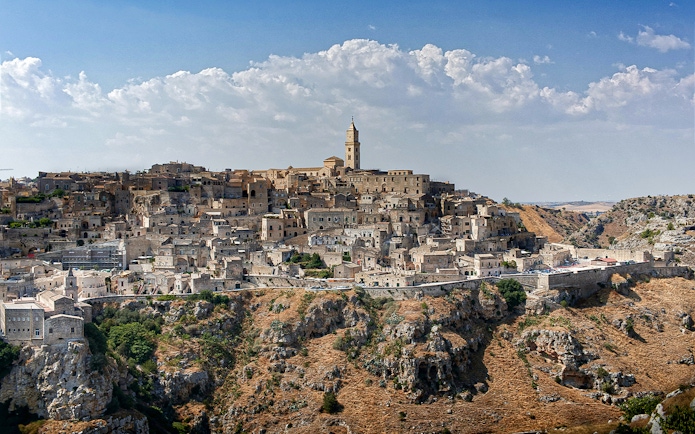 Matera's ancient stone cityscape with historic churches in Murgia Park.