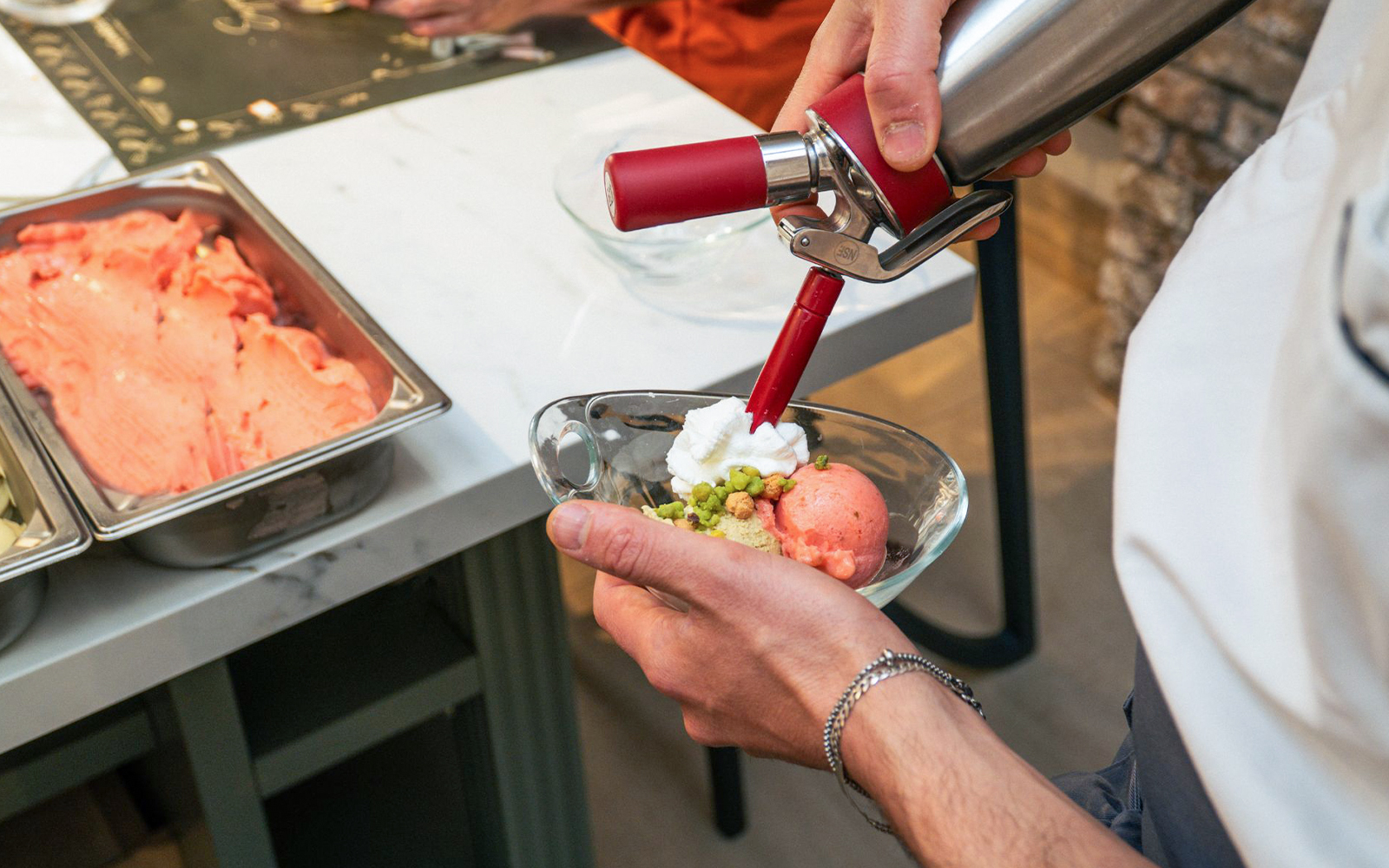 Gelato being prepared in a traditional Italian gelateria, Rome, Italy.
