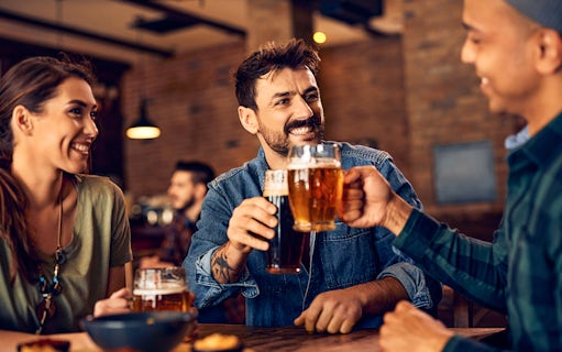 People enjoying beer together in a lively pub setting.