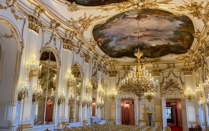 Schonbrunn Palace interior with ornate chandeliers and frescoed ceiling, Vienna.
