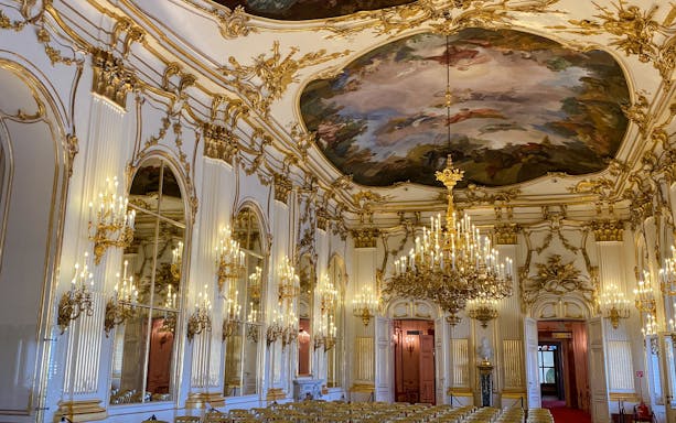 Schonbrunn Palace interior with ornate chandeliers and frescoed ceiling, Vienna.