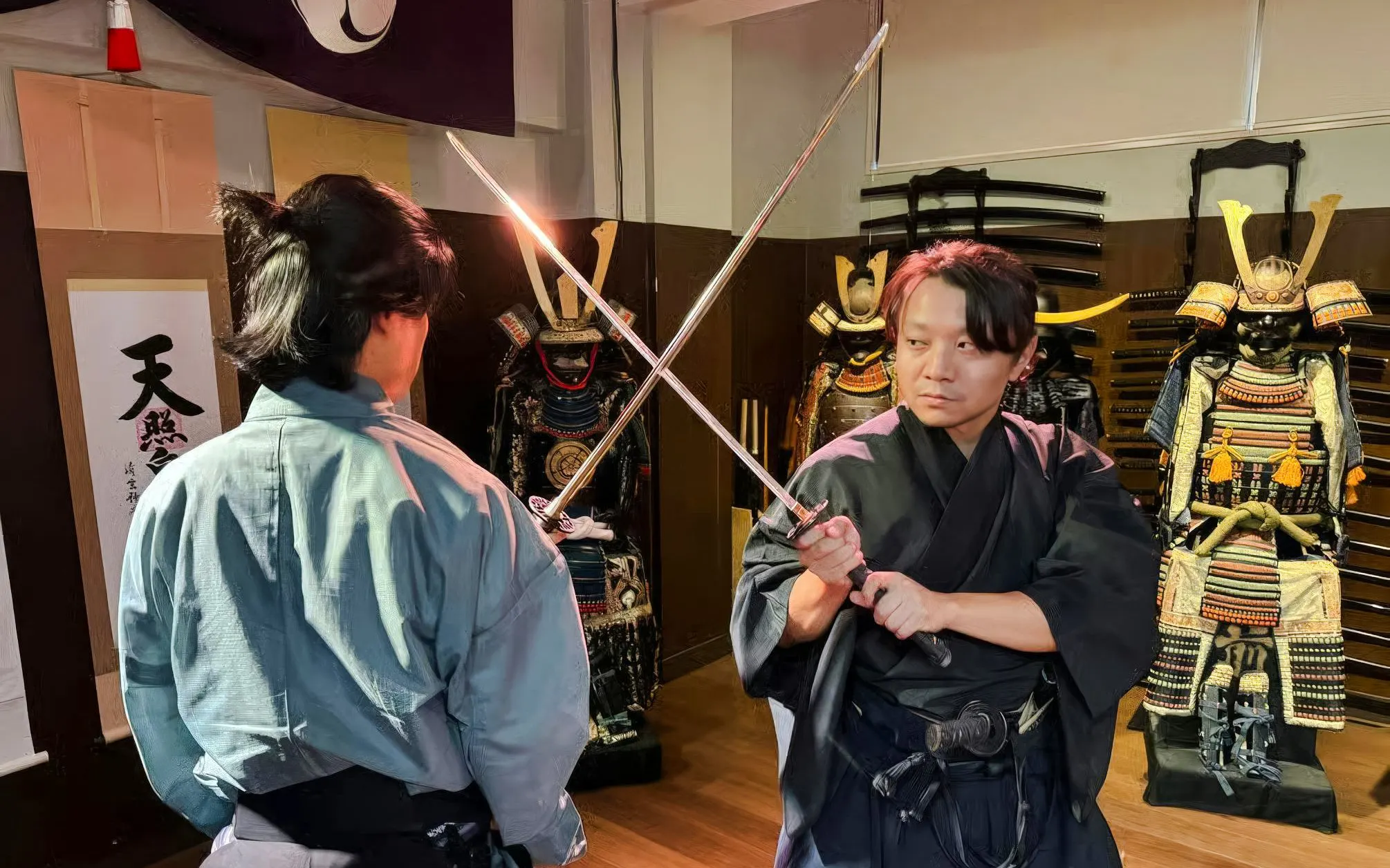Samurai sword fight demonstration at Samurai Experience with traditional armor in background.