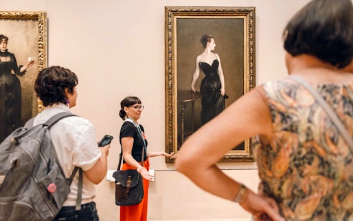 Tour guide explaining artwork at the Metropolitan Museum of Art.