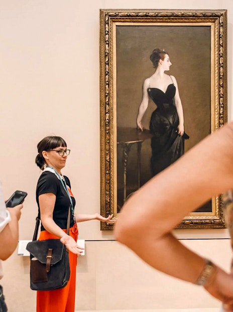Tour guide explaining artwork at the Metropolitan Museum of Art.