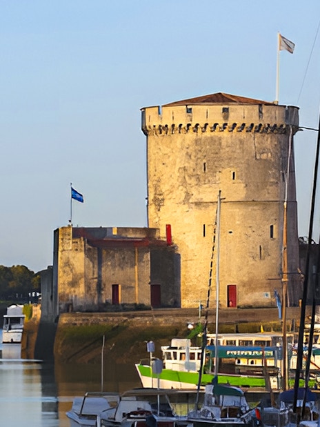 Towers of La Rochelle with boats in the harbor, France.