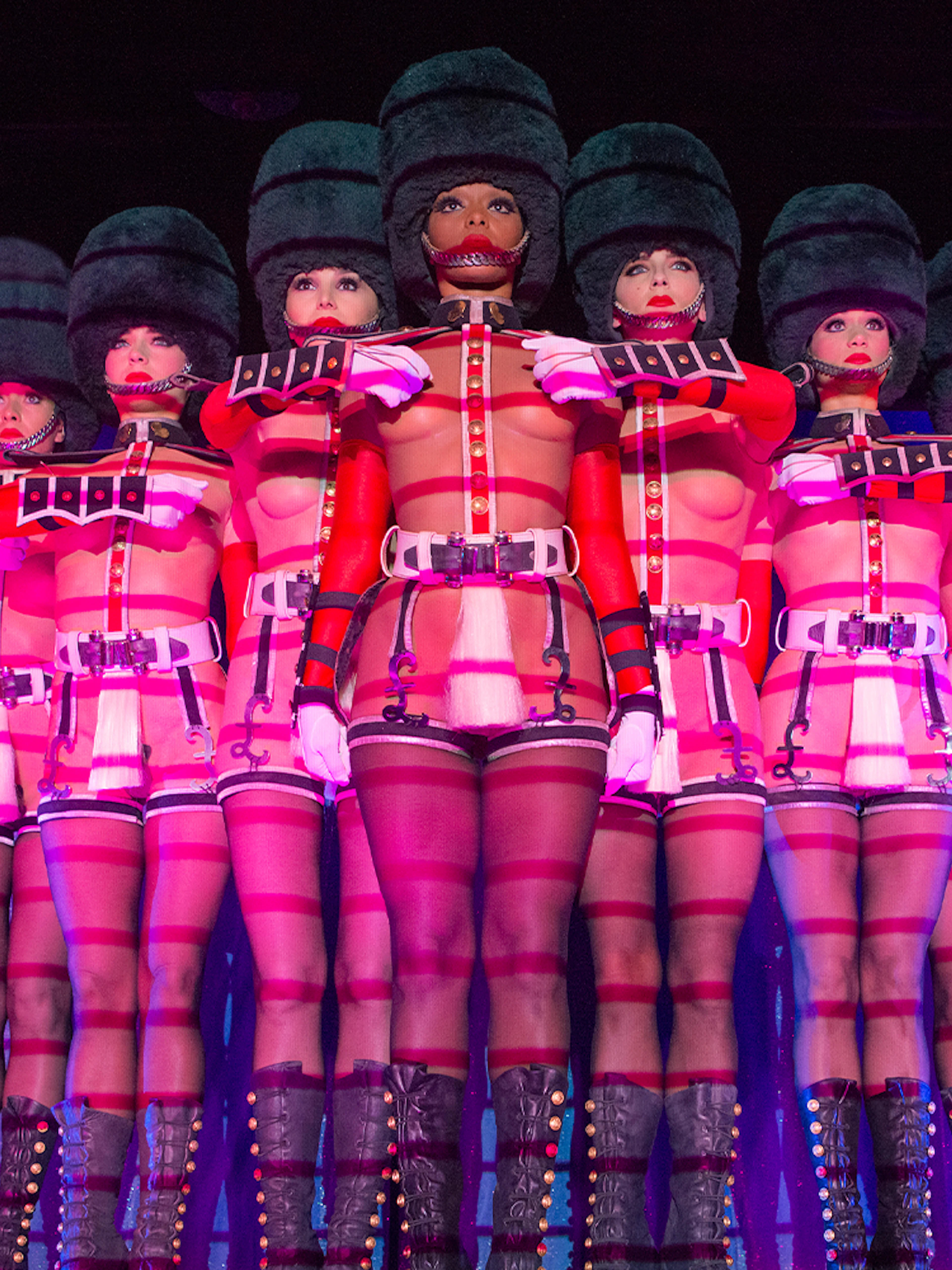 Performers in uniform costumes at Crazy Horse Cabaret Show, Paris.