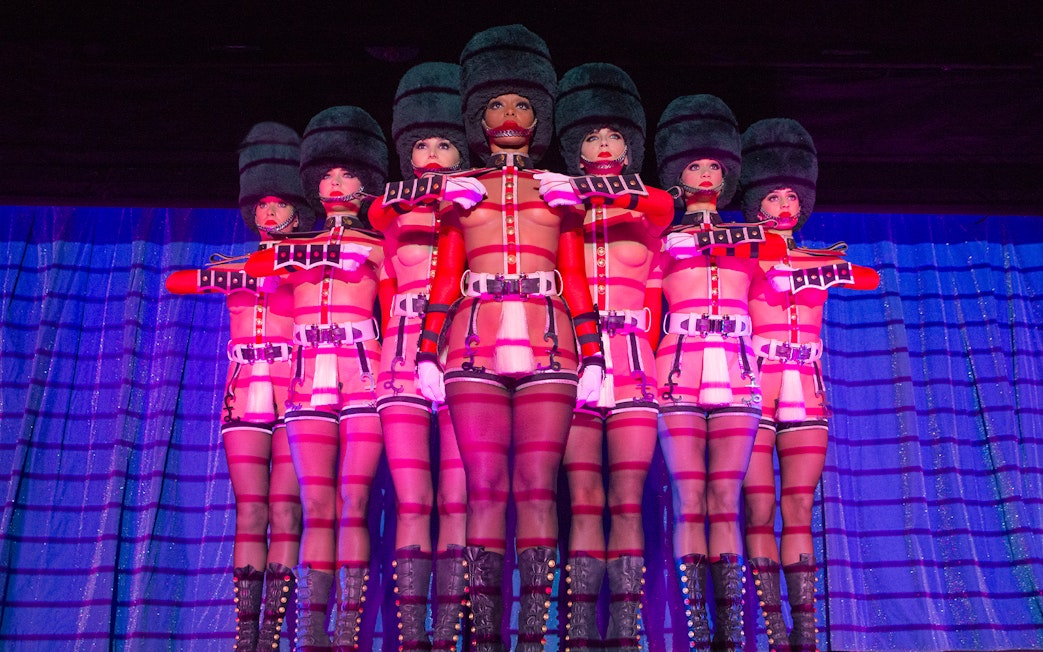 Performers in uniform costumes at Crazy Horse Cabaret Show, Paris.