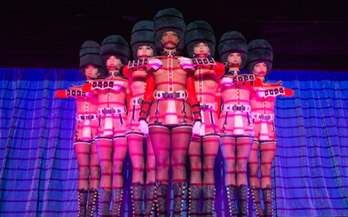 Performers in uniform costumes at Crazy Horse Cabaret Show, Paris.