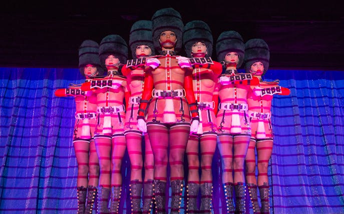 Performers in uniform costumes at Crazy Horse Cabaret Show, Paris.