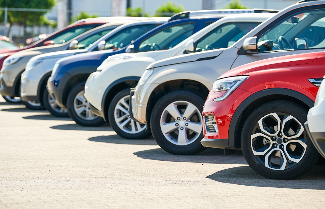 Cars lined up in a parking lot.