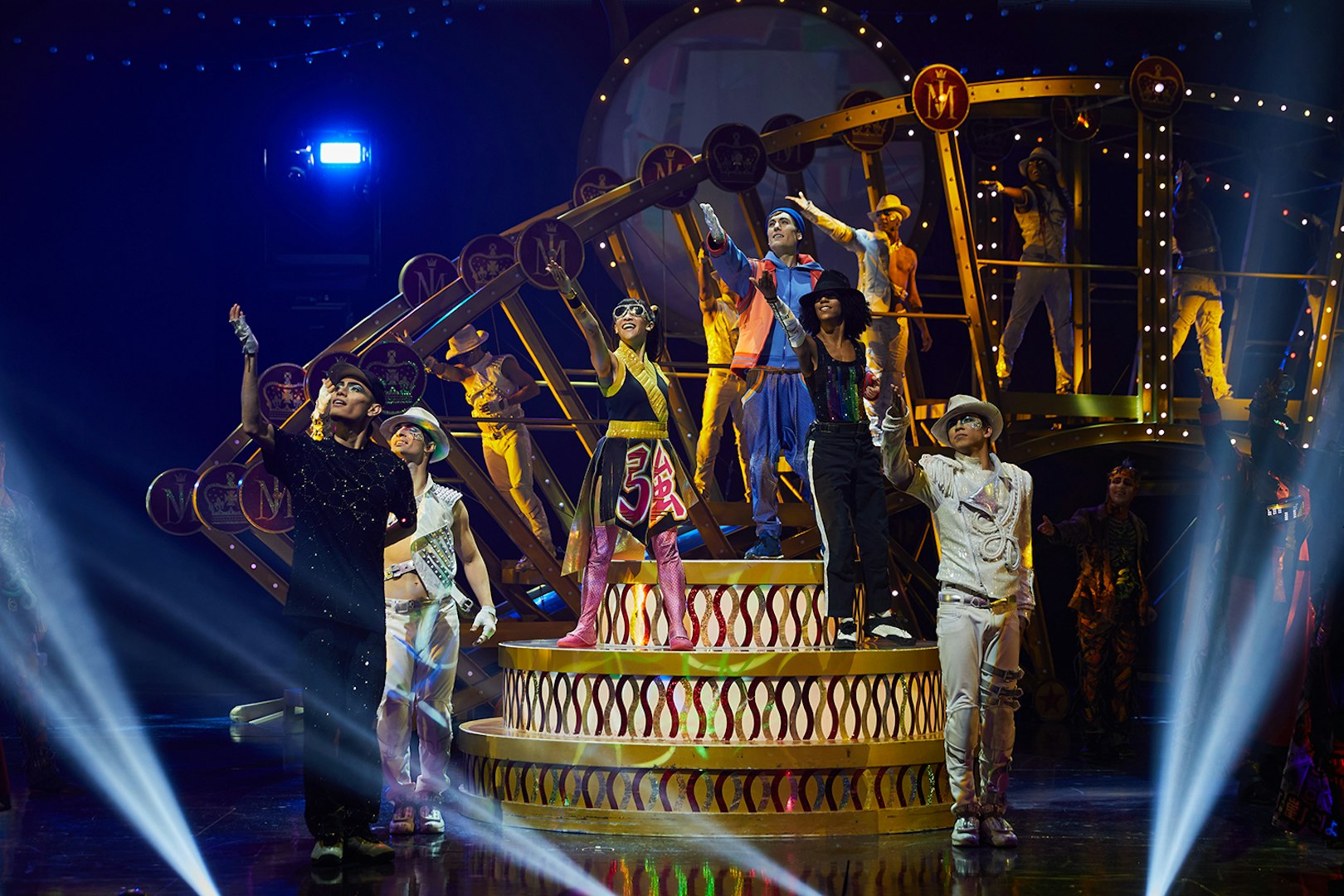 Performers on stage during Michael Jackson ONE show in Las Vegas, featuring vibrant costumes and dynamic poses.