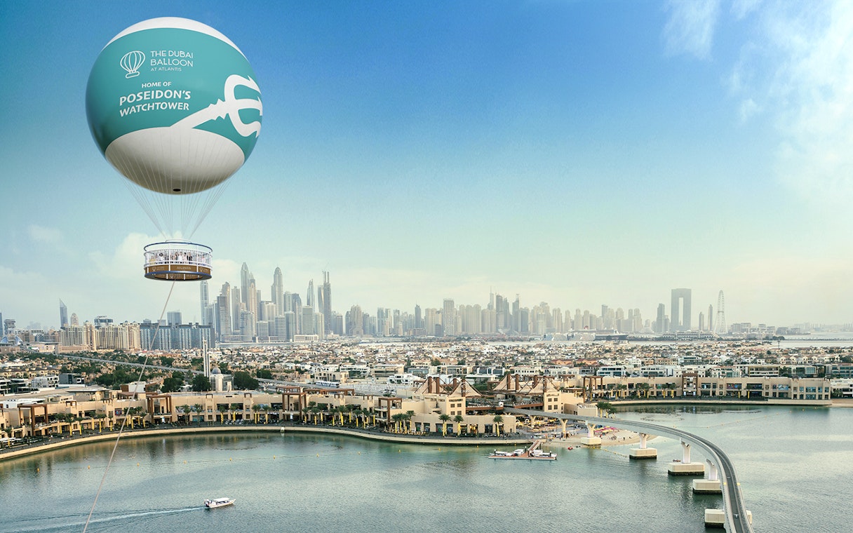 Dubai skyline with The Dubai Balloon at Atlantis floating above Palm Jumeirah.