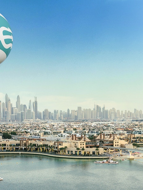 Dubai skyline with The Dubai Balloon at Atlantis floating above Palm Jumeirah.