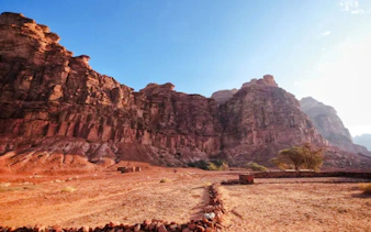 Rocky landscape of Hegra in AlUla, Saudi Arabia, with ancient stone formations and desert terrain.