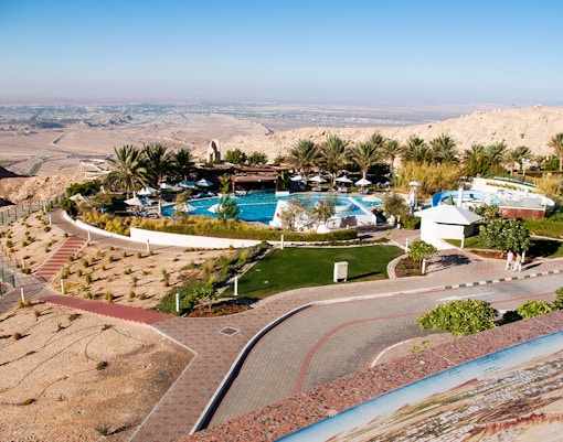 Al Ain oasis view with pool and gardens, part of Dubai to Al Ain day trip.