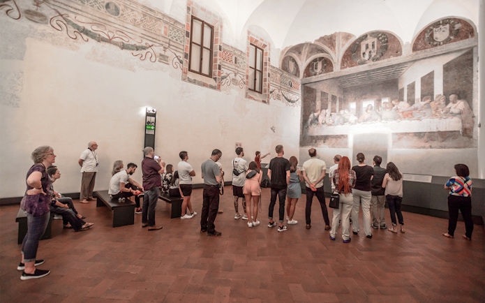 Visitors viewing the Last Supper painting in Milan during a city walking tour.