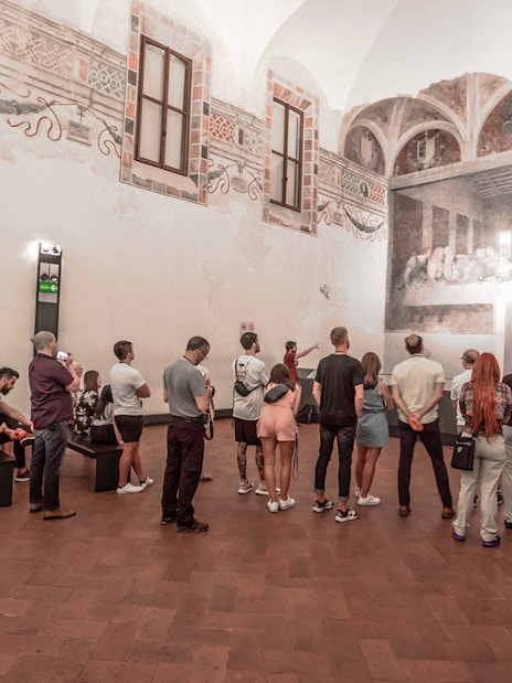 Visitors viewing the Last Supper painting in Milan during a city walking tour.