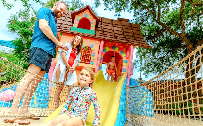 Child sliding down colorful slide at Storybrook, Schlitterbahn New Braunfels.