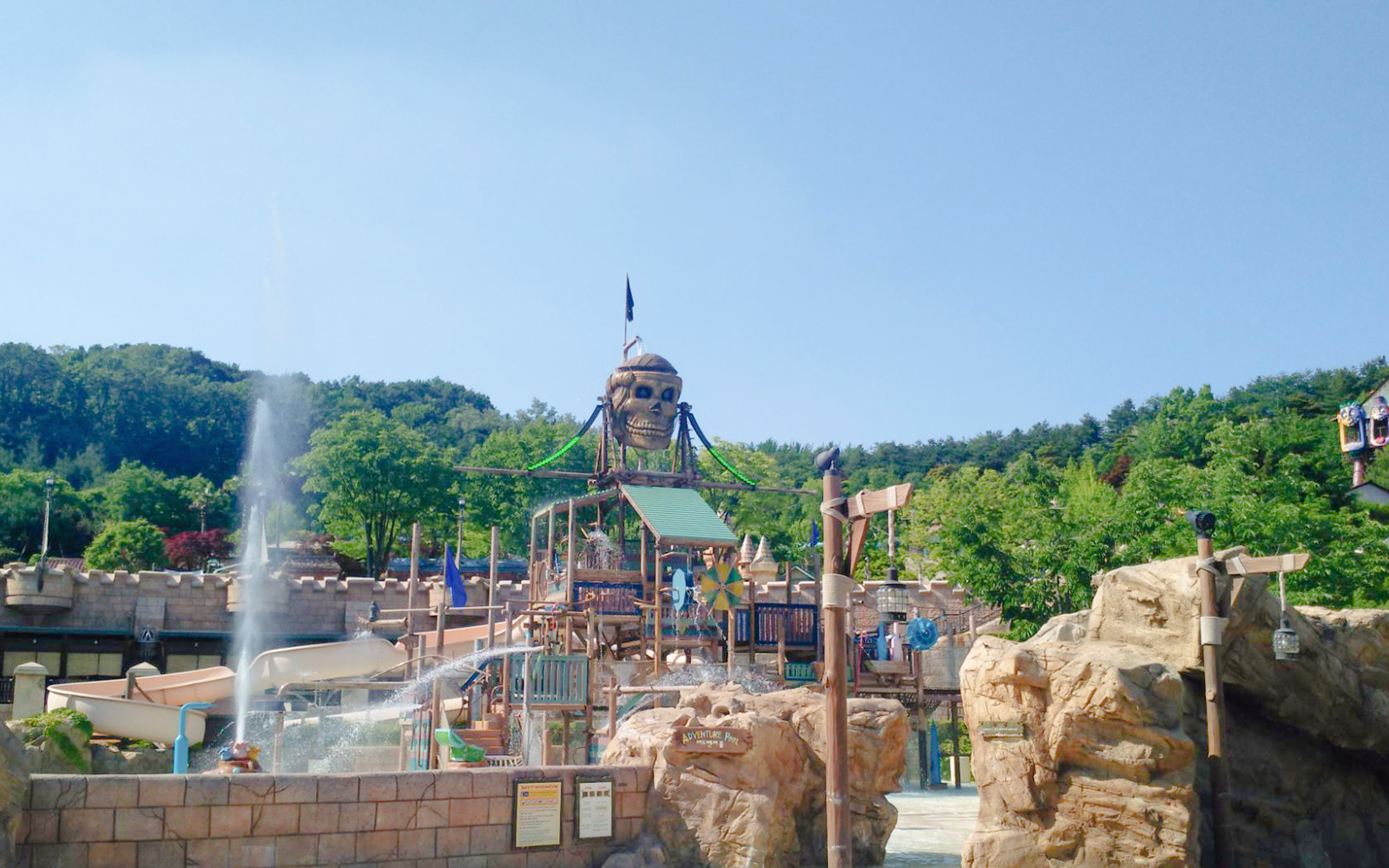 Pirate-themed water ride at Caribbean Bay Water Park with slides and fountains.
