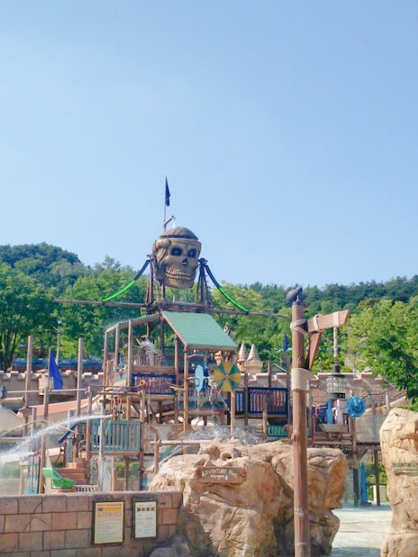 Pirate-themed water ride at Caribbean Bay Water Park with slides and fountains.