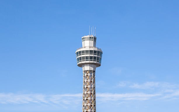 Yokohama Marine Tower against a clear blue sky.