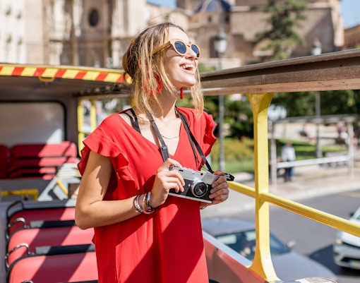 Tourist enjoying a city tour on an open-top bus miami