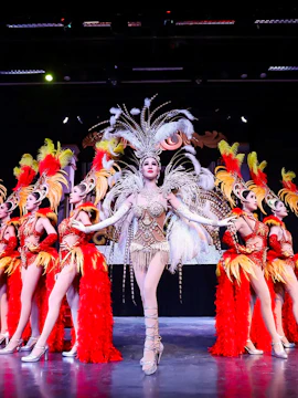 Performers in elaborate costumes on stage at Miracle Cabaret Show.