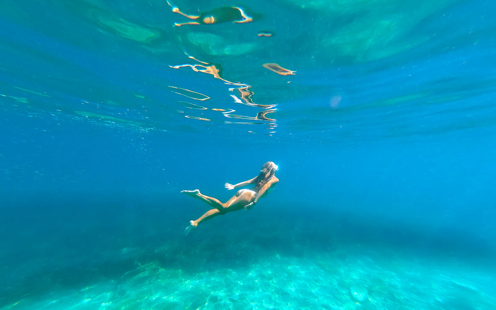 Swimming in clear waters during Blue Lagoon boat tour from Split.